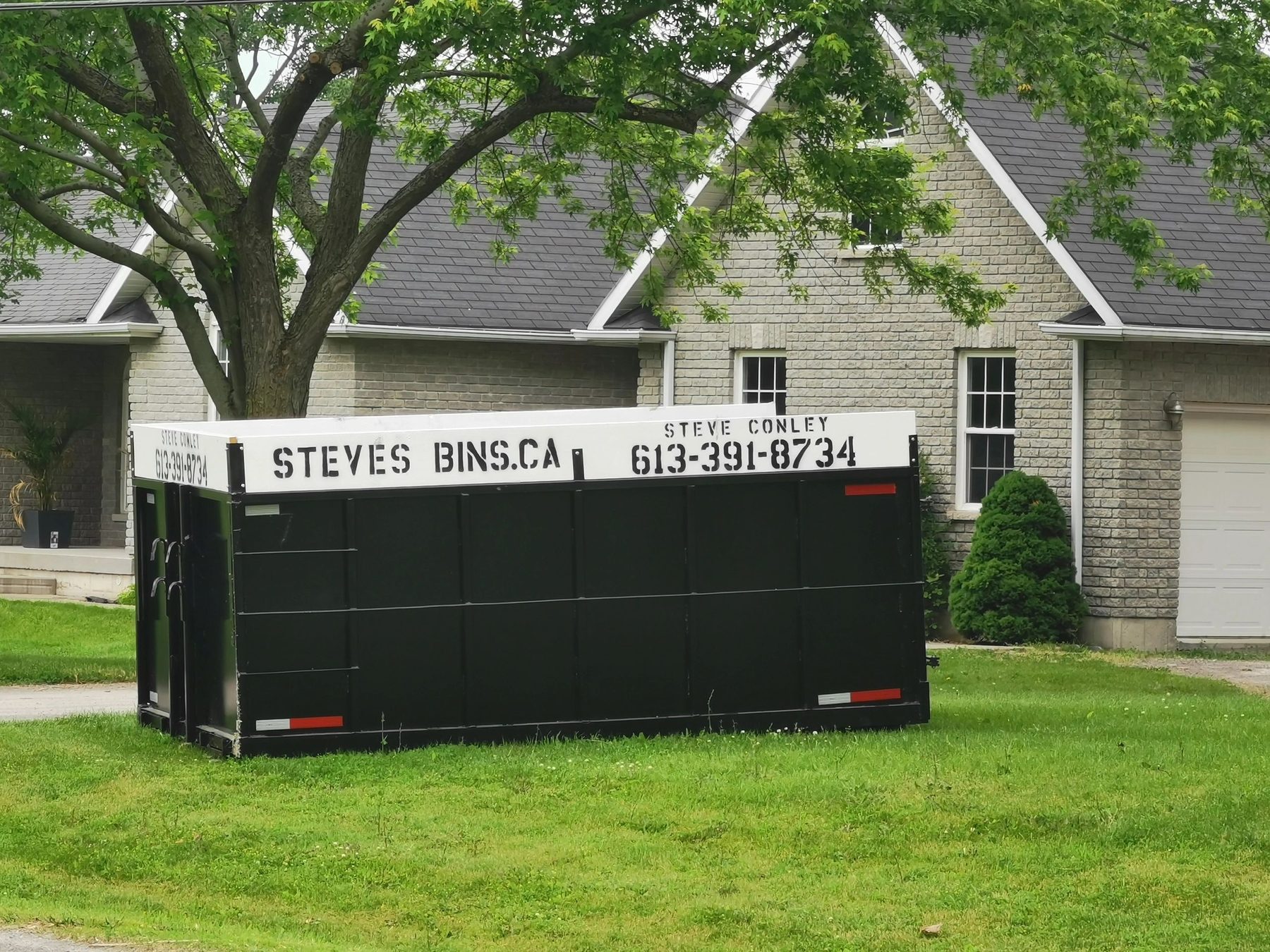 Steve's Bins black roll-off disposal bin delivered to a residential property